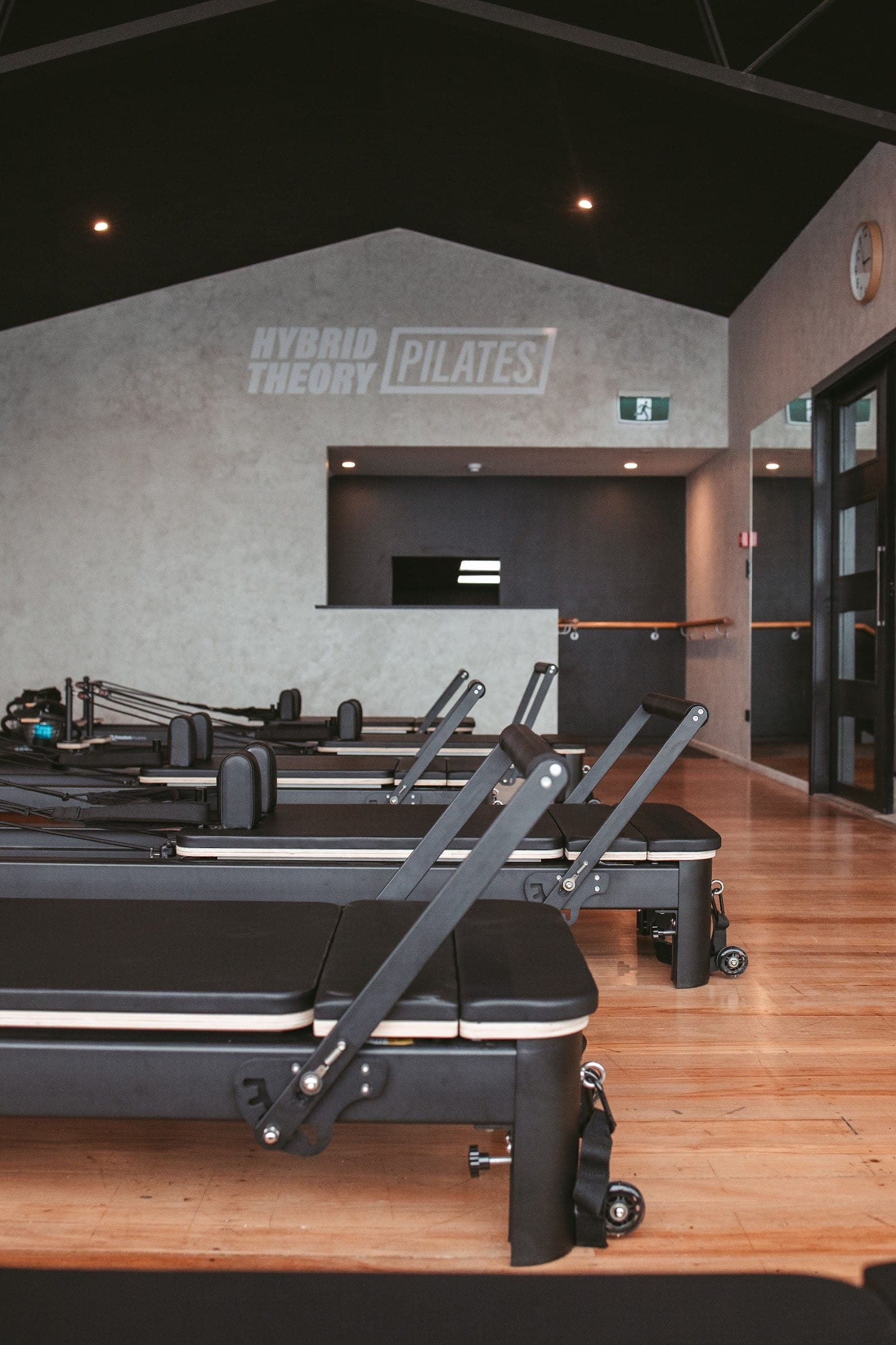 The Hybrid Theory Pilates studio with reformer beds, barre and check-in desk