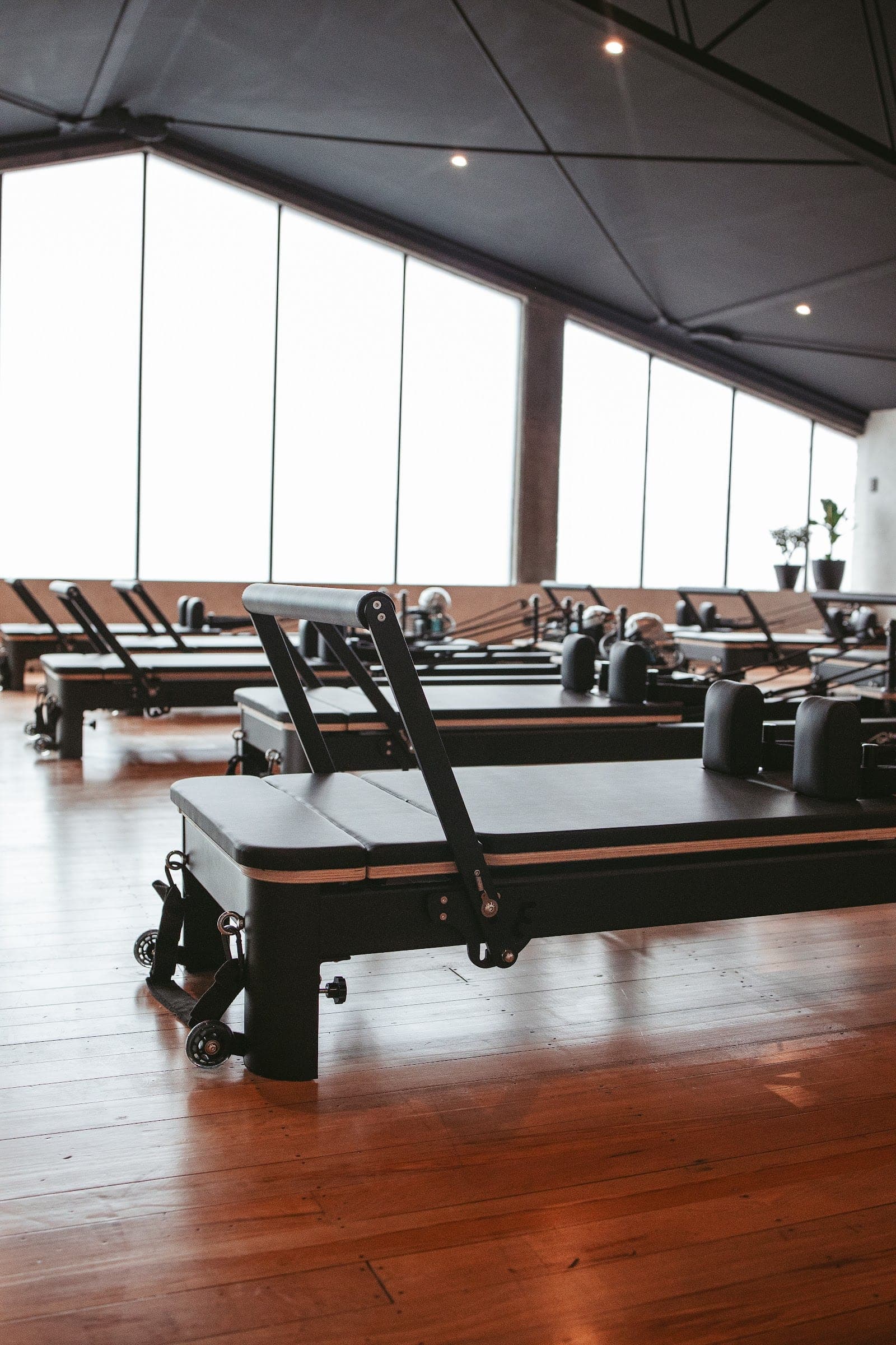 The upstairs studio beneath the raked ceiling and floor-to-ceiling windows, now home to KLUB Pilates