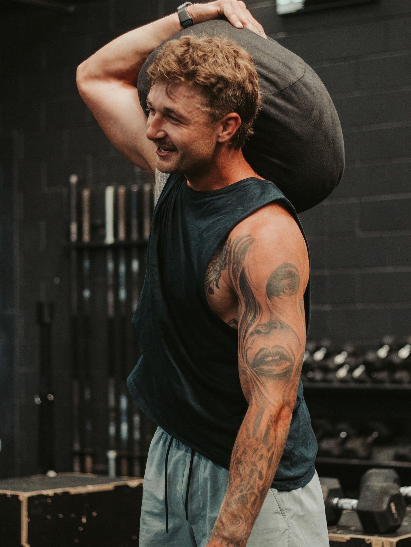 Member carrying a sandbag during Hybrid Training
