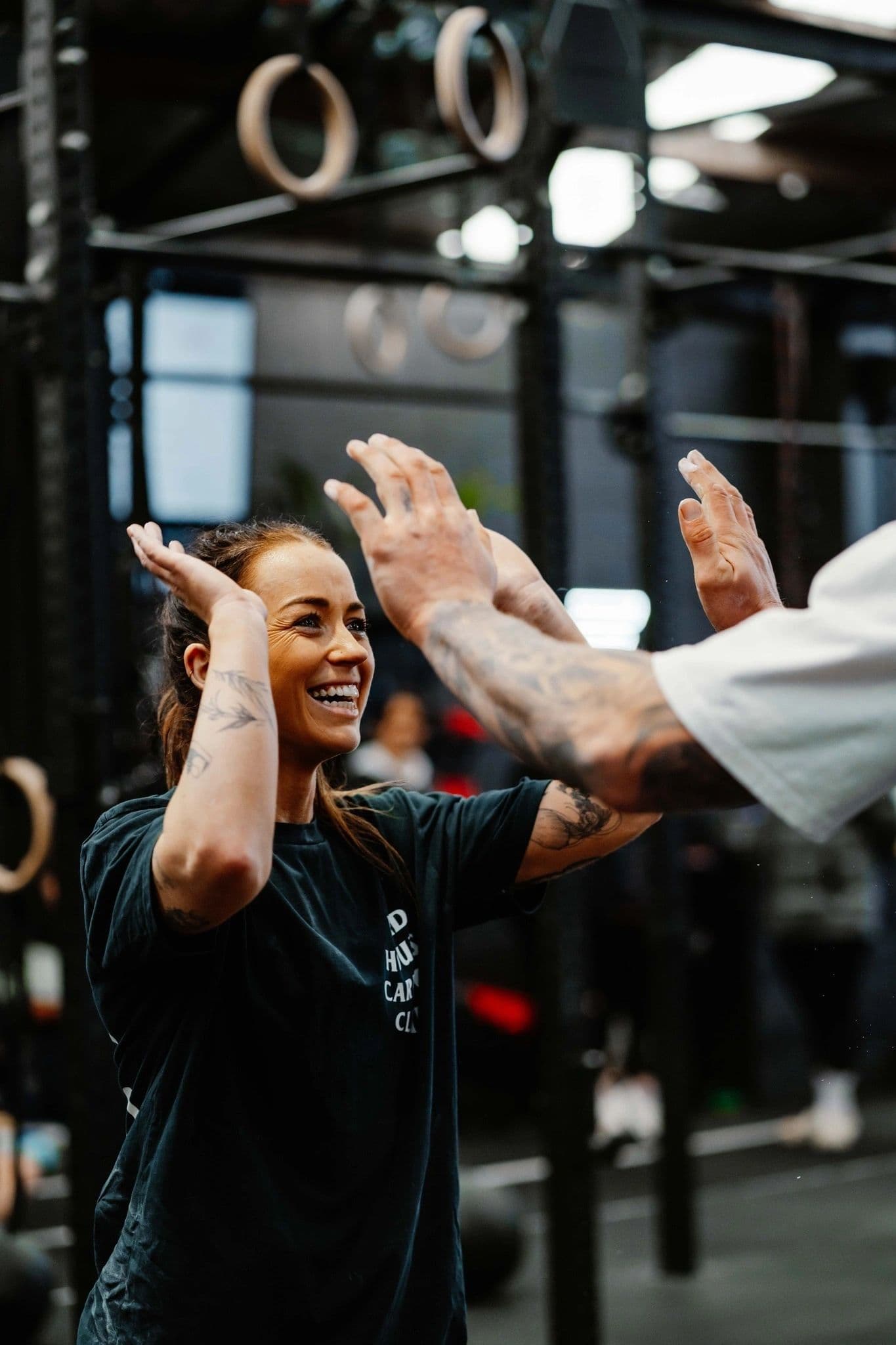 Coach and member high-fiving mid-session