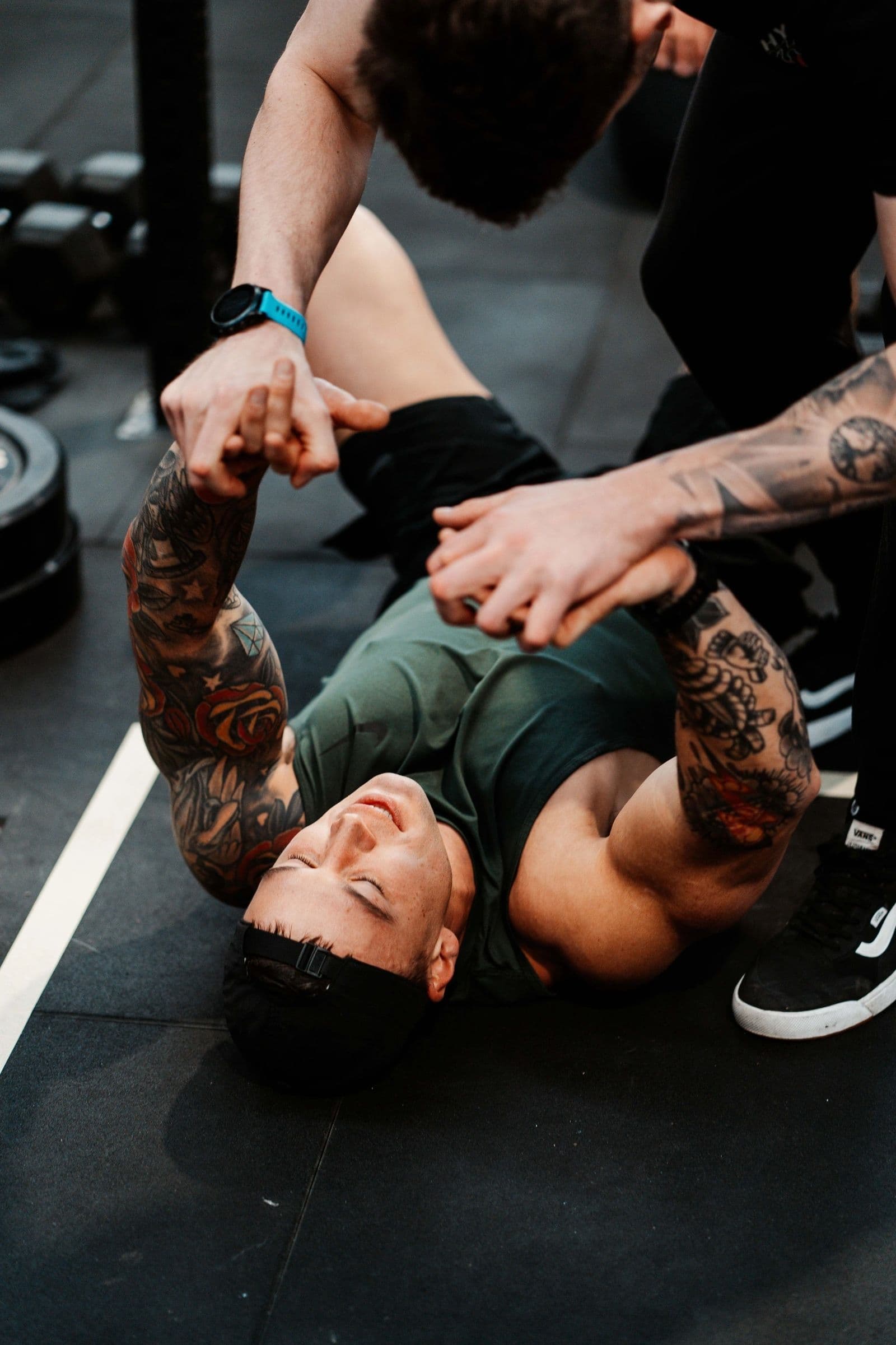 Coach guiding a member through floor work
