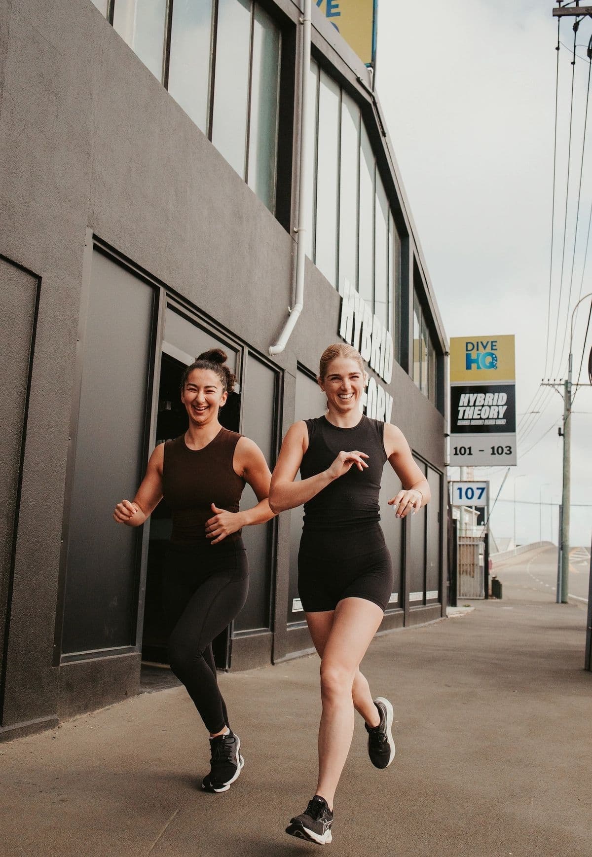 Two members running outside Hybrid Theory Training on Durham Street