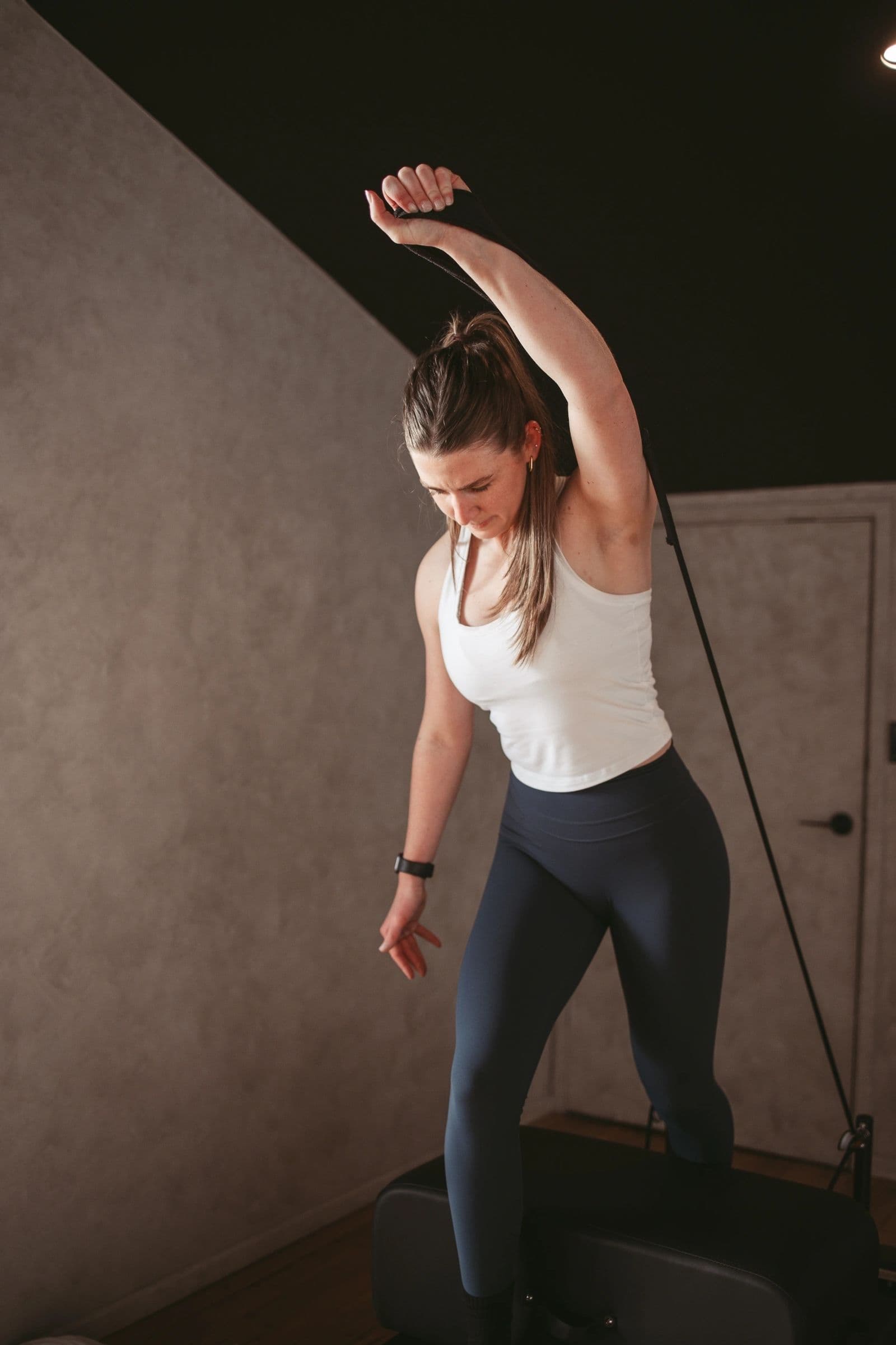 Member stretching through a side bend on the reformer at Hybrid Theory
