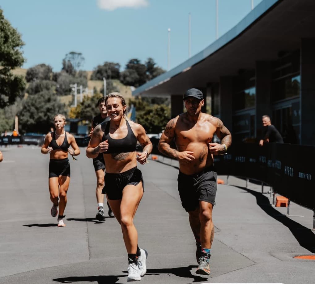 Runners mid-race in motion blur during a HYROX event